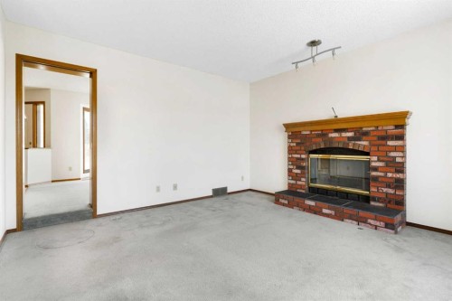190 Hawkville Close Nw, Calgary, AB - Indoor Photo Showing Living Room With Fireplace