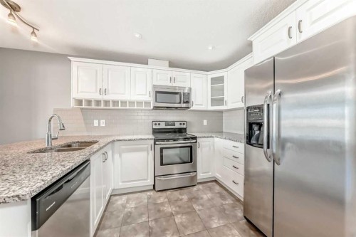 147 Windford Crescent Sw, Airdrie, AB - Indoor Photo Showing Kitchen With Double Sink With Upgraded Kitchen
