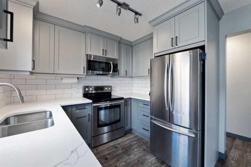 11 Woodside Circle, Airdrie, AB - Indoor Photo Showing Kitchen With Stainless Steel Kitchen With Double Sink