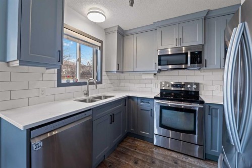 11 Woodside Circle, Airdrie, AB - Indoor Photo Showing Kitchen With Stainless Steel Kitchen With Double Sink