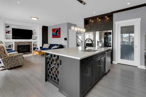 1112 Iron Landing Way, Crossfield, AB - Indoor Photo Showing Kitchen With Fireplace With Double Sink