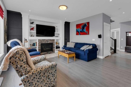 1112 Iron Landing Way, Crossfield, AB - Indoor Photo Showing Living Room With Fireplace