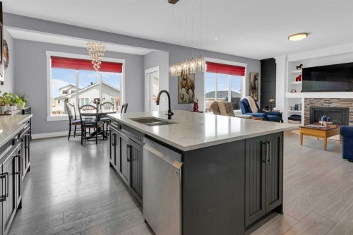 1112 Iron Landing Way, Crossfield, AB - Indoor Photo Showing Kitchen With Fireplace With Double Sink