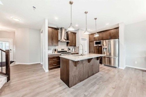 151 Sundown Way, Cochrane, AB - Indoor Photo Showing Kitchen With Double Sink With Upgraded Kitchen