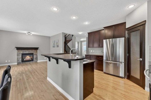 43 Heritage Hill, Cochrane, AB - Indoor Photo Showing Kitchen With Fireplace