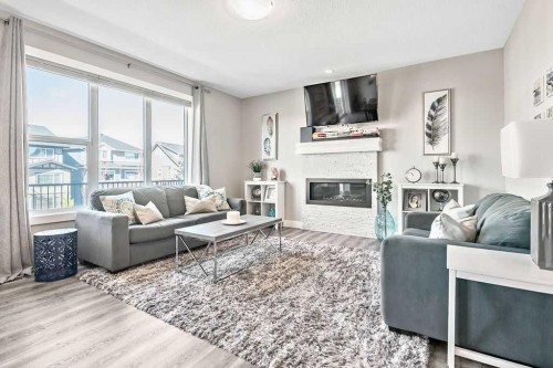 75 Sundown Way, Cochrane, AB - Indoor Photo Showing Living Room With Fireplace