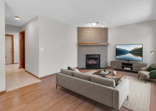 260 Hawkwood Boulevard Nw, Calgary, AB - Indoor Photo Showing Living Room With Fireplace