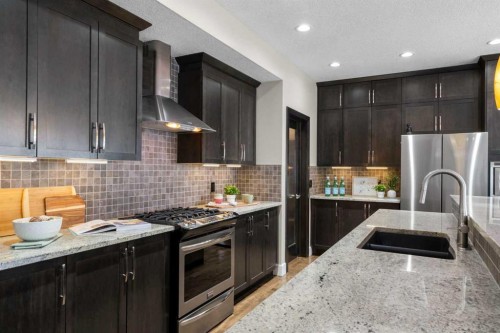 809 Canoe Green Sw, Airdrie, AB - Indoor Photo Showing Kitchen With Double Sink With Upgraded Kitchen