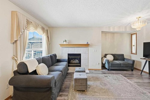 63 Anaheim Crescent Ne, Calgary, AB - Indoor Photo Showing Living Room With Fireplace