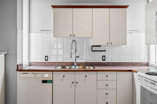 14700 Mt Mckenzie Drive Se, Calgary, AB - Indoor Photo Showing Kitchen With Double Sink