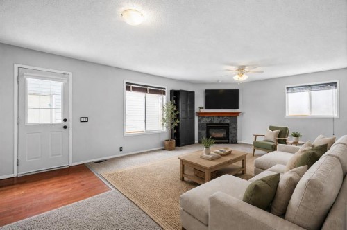 14700 Mt Mckenzie Drive Se, Calgary, AB - Indoor Photo Showing Living Room With Fireplace