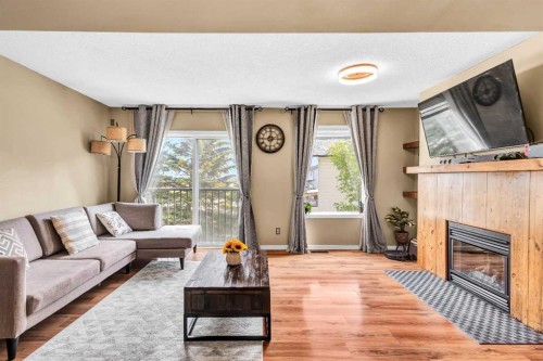 3-200 Hidden Hills Terrace Nw, Calgary, AB - Indoor Photo Showing Living Room With Fireplace