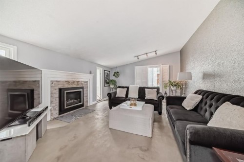 5519 Buckthorn Road Nw, Calgary, AB - Indoor Photo Showing Living Room With Fireplace
