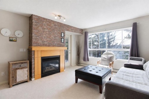 216-5115 Richard Road Sw, Calgary, AB - Indoor Photo Showing Living Room With Fireplace