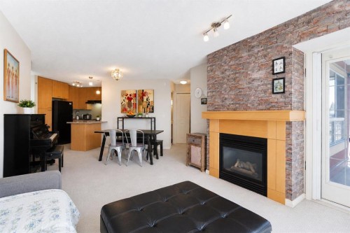 216-5115 Richard Road Sw, Calgary, AB - Indoor Photo Showing Living Room With Fireplace