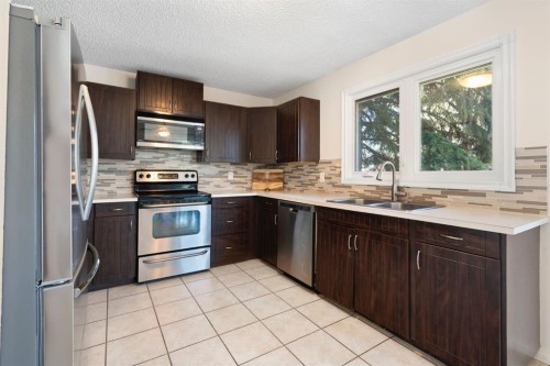 48 Midpark Gardens Se, Calgary, AB - Indoor Photo Showing Kitchen With Stainless Steel Kitchen With Double Sink