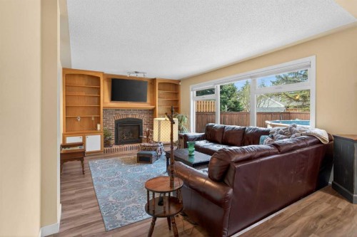 1486 Sunwood Road Se, Calgary, AB - Indoor Photo Showing Living Room With Fireplace