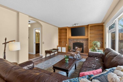 1486 Sunwood Road Se, Calgary, AB - Indoor Photo Showing Living Room With Fireplace