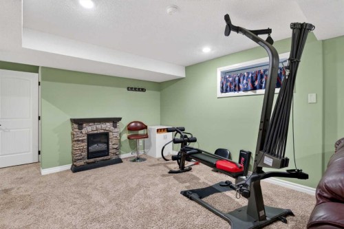 1486 Sunwood Road Se, Calgary, AB - Indoor Photo Showing Gym Room