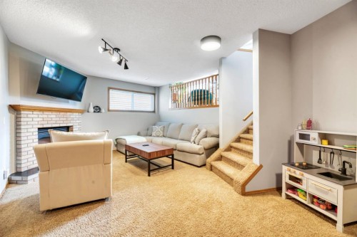 32 Somercrest Manor Sw, Calgary, AB - Indoor Photo Showing Other Room With Fireplace