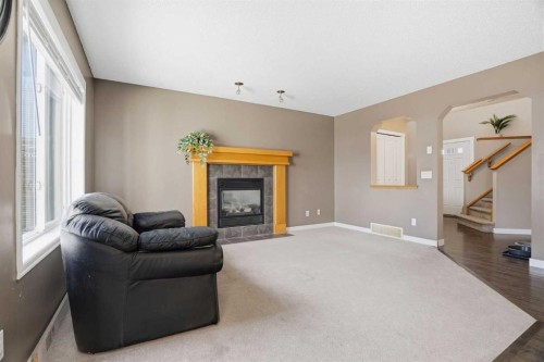 202 New Brighton Manor Se, Calgary, AB - Indoor Photo Showing Living Room With Fireplace