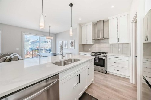 81 Willow Court, Cochrane, AB - Indoor Photo Showing Kitchen With Double Sink With Upgraded Kitchen