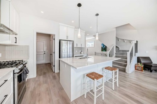 81 Willow Court, Cochrane, AB - Indoor Photo Showing Kitchen With Double Sink With Upgraded Kitchen