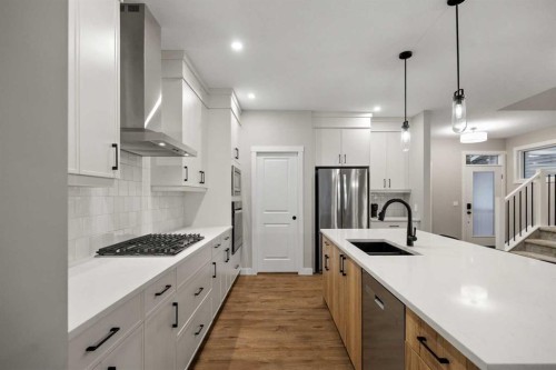 135 Silver Spruce Grove Sw, Calgary, AB - Indoor Photo Showing Kitchen With Double Sink With Upgraded Kitchen