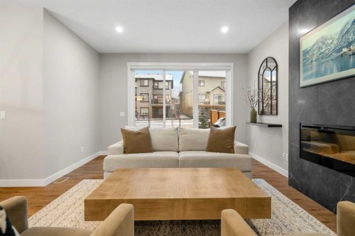 135 Silver Spruce Grove Sw, Calgary, AB - Indoor Photo Showing Living Room With Fireplace