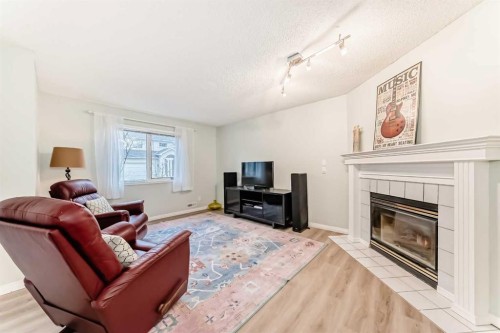 19 Sunlake Gardens Se, Calgary, AB - Indoor Photo Showing Living Room With Fireplace