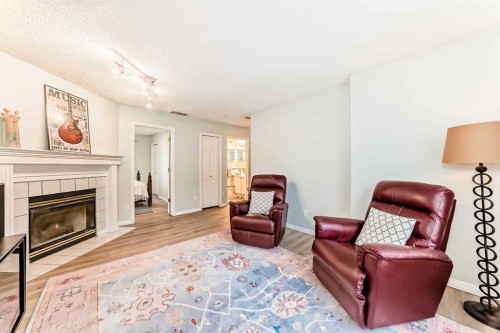19 Sunlake Gardens Se, Calgary, AB - Indoor Photo Showing Living Room With Fireplace