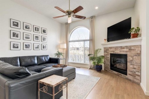 402 Rocky Ridge Cove Nw, Calgary, AB - Indoor Photo Showing Living Room With Fireplace