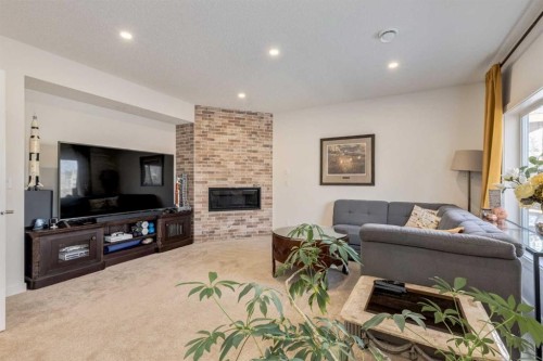 402 Rocky Ridge Cove Nw, Calgary, AB - Indoor Photo Showing Living Room With Fireplace