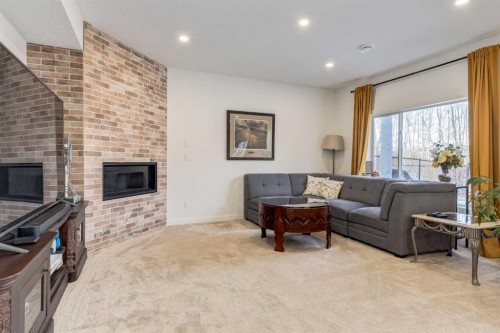 402 Rocky Ridge Cove Nw, Calgary, AB - Indoor Photo Showing Living Room With Fireplace