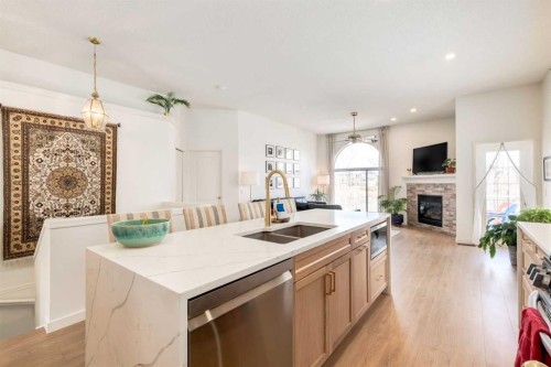 402 Rocky Ridge Cove Nw, Calgary, AB - Indoor Photo Showing Kitchen With Fireplace With Double Sink