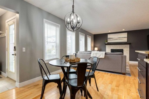 16 Prestwick Road Se, Calgary, AB - Indoor Photo Showing Dining Room With Fireplace