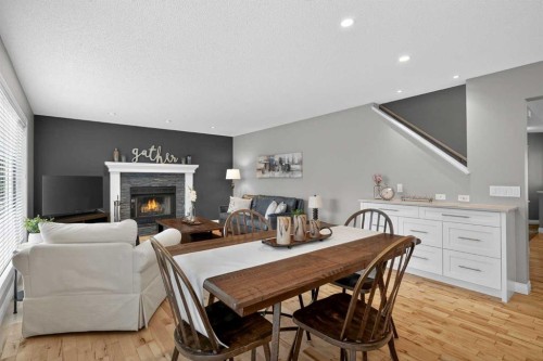 3513 Douglas Woods Heights Se, Calgary, AB - Indoor Photo Showing Dining Room With Fireplace
