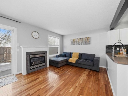 101 Everstone Place Sw, Calgary, AB - Indoor Photo Showing Living Room With Fireplace