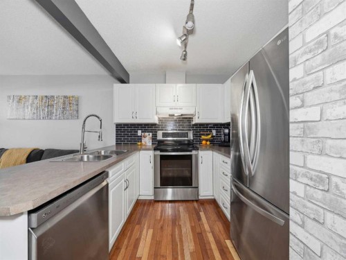 101 Everstone Place Sw, Calgary, AB - Indoor Photo Showing Kitchen With Stainless Steel Kitchen With Double Sink With Upgraded Kitchen