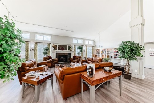 446-15 Everstone Drive Sw, Calgary, AB - Indoor Photo Showing Living Room With Fireplace