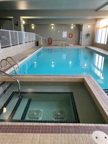 446-15 Everstone Drive Sw, Calgary, AB - Indoor Photo Showing Other Room With In Ground Pool