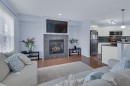 273 Eversyde Boulevard Sw, Calgary, AB  - Indoor Photo Showing Living Room With Fireplace 
