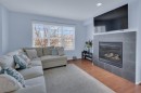 273 Eversyde Boulevard Sw, Calgary, AB  - Indoor Photo Showing Living Room With Fireplace 