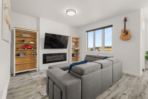 1041 Iron Landing Way, Crossfield, AB - Indoor Photo Showing Living Room With Fireplace