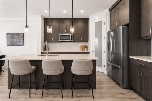 1041 Iron Landing Way, Crossfield, AB - Indoor Photo Showing Kitchen With Stainless Steel Kitchen With Upgraded Kitchen