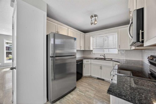84 Macewan Glen Way Nw, Calgary, AB - Indoor Photo Showing Kitchen With Double Sink