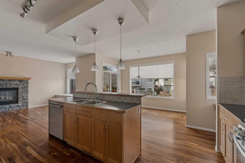 11 Valley Crest Rise Nw, Calgary, AB - Indoor Photo Showing Kitchen With Fireplace With Double Sink