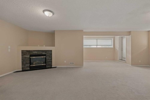 11 Valley Crest Rise Nw, Calgary, AB - Indoor Photo Showing Living Room With Fireplace