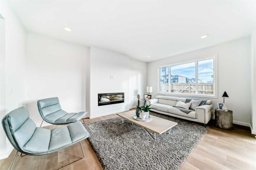 64 Creekside Path Sw, Calgary, AB - Indoor Photo Showing Living Room With Fireplace