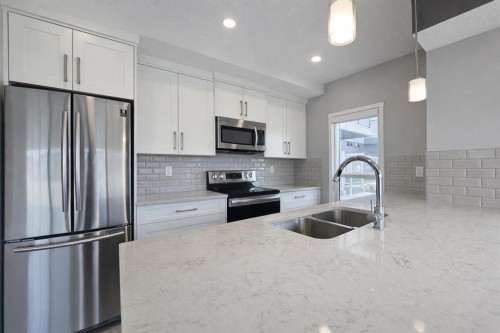 109-4150 Seton Drive Se, Calgary, AB - Indoor Photo Showing Kitchen With Stainless Steel Kitchen With Double Sink With Upgraded Kitchen